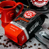 A 12 oz bag of Fire Department Coffee's Jobtown Extra Strength Coffee surrounded by firefighter tools and an FDC Hydrant Mug.