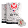 Two boxes of FDC Fire Department Spirit Infused Coffee next to a single vanilla bean coffee capsule on a white background.