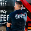 A man facing a fire truck wearing the Always on Call Tee