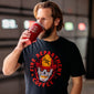 A man wearing the Skull Shirt, drinking from the FDC Red Tumbler.