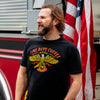 A man standing in front of a fire truck and an American flag. He is wearing the US Eagle Shirt.