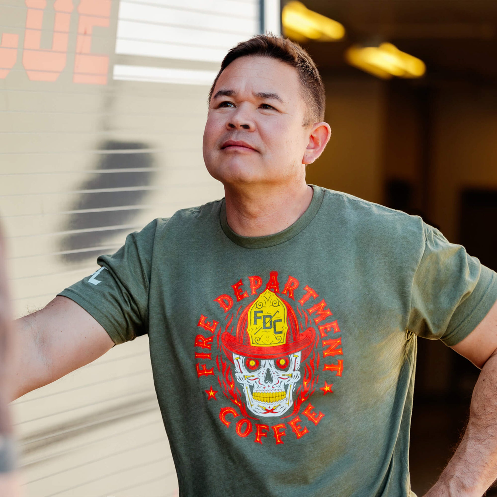 A military green t-shirt with a skull design on the front and text that reads FIRE DEPARTMENT COFFEE