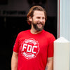 An image of a man wearing the Fire Department Coffee Red Shirt