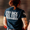 A woman in the Stay Back Shirt in Navy facing away.