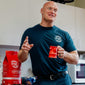 An image of a man wearing the Navy Stay Back shirt holding a Hydrant Mug