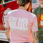 A woman facing away from the camera, wearing the Pink Stay Back Shirt