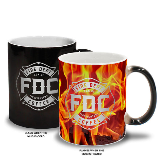 Two mugs: one showing the black mug with the FDC maltese cross logo on it when cold on the left, and the flames that appear on the mug when hot on the right.