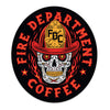 Sticker with a skull wearing an FDC fire helmet surrounded by flames in the center. Around the skull is text that reads "Fire Department Coffee".